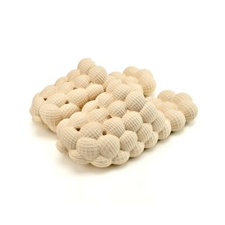 A heap of natural wood textured spheres compacted together, creating a repetitive geometric pattern.