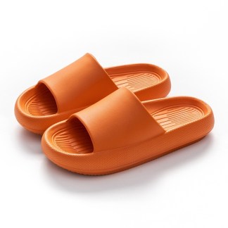 Vibrant orange slide sandals with a textured design on the insoles and simple wide straps, presented on a white background.