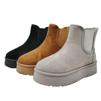 A collection of three suede ankle boots in black, tan, and grey, each featuring elastic side panels and thick, contrasting rubber soles.